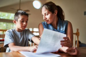 Mom helping son do homework.